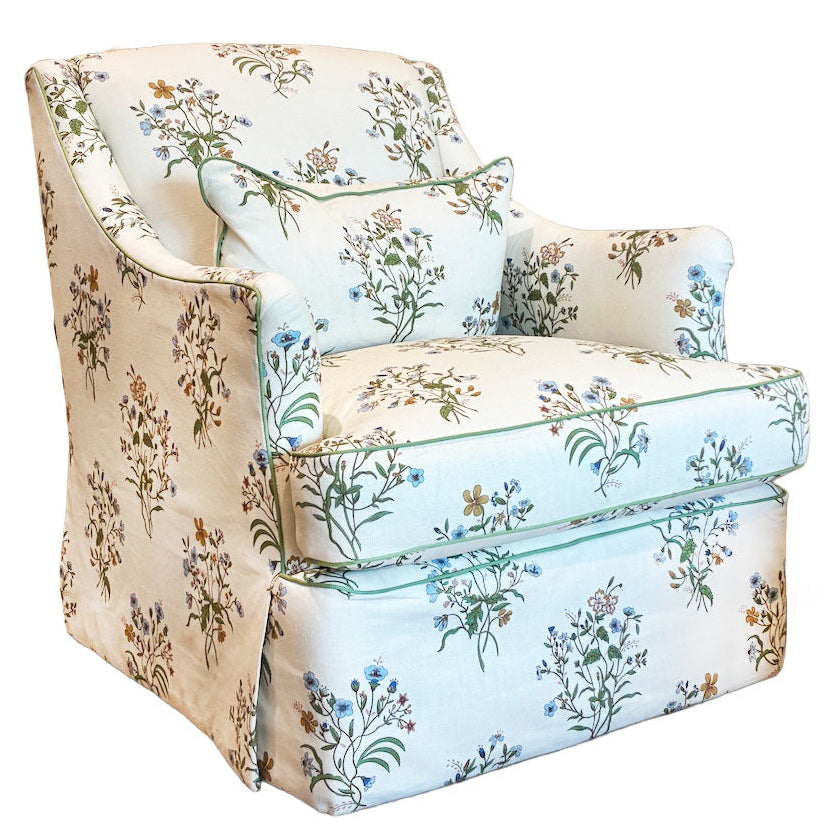 The Bowen Arm Chair in Flax & Field Flowers by Bunny Williams features elegant slipcover upholstery, a skirted base, subtle floral print, and comes with a matching cushion for added charm.