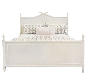 The Bambu King Bed by Sherrill/Mr & Mrs Howard features turned posts and a decorative headboard, creating timeless style. Shown here dressed with floral bedding and three pillows for an inviting bedroom look.