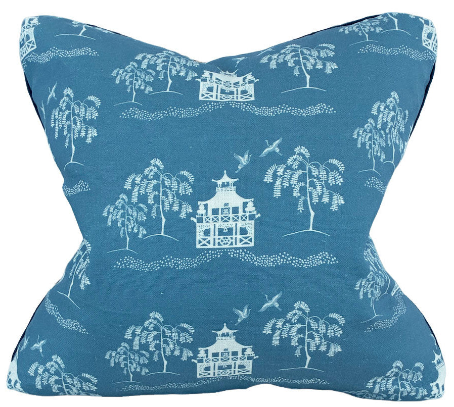The Fall Pagoda Blue Pillow by Hive Custom Pillows features a blue background with white trees, pagodas, and birds, crafted from premium materials for comfort and style in your home.