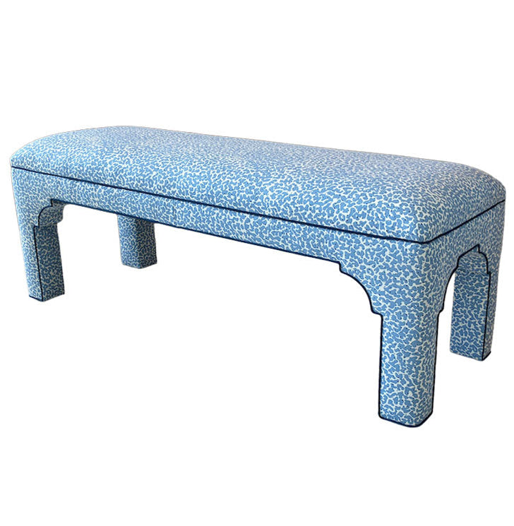 The Taj Bench by Bunny Williams features a blue and white patterned upholstered seat, a maple frame, and four sturdy curved legs.