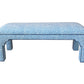 The Taj Bench by Bunny Williams features a sturdy maple frame, four legs, and light blue upholstery with a subtle white speckled pattern.