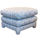 The Empire Ottoman from Bunny Williams features two stacked square cushions in blue Grande Gran patterned fabric on short legs—an elegant accent perfect for adding style and comfort to your bedroom.