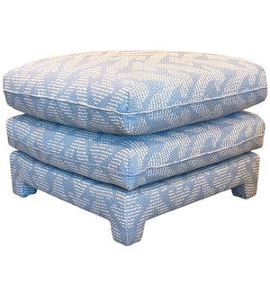 The Empire Ottoman from Bunny Williams features two stacked square cushions in blue Grande Gran patterned fabric on short legs—an elegant accent perfect for adding style and comfort to your bedroom.