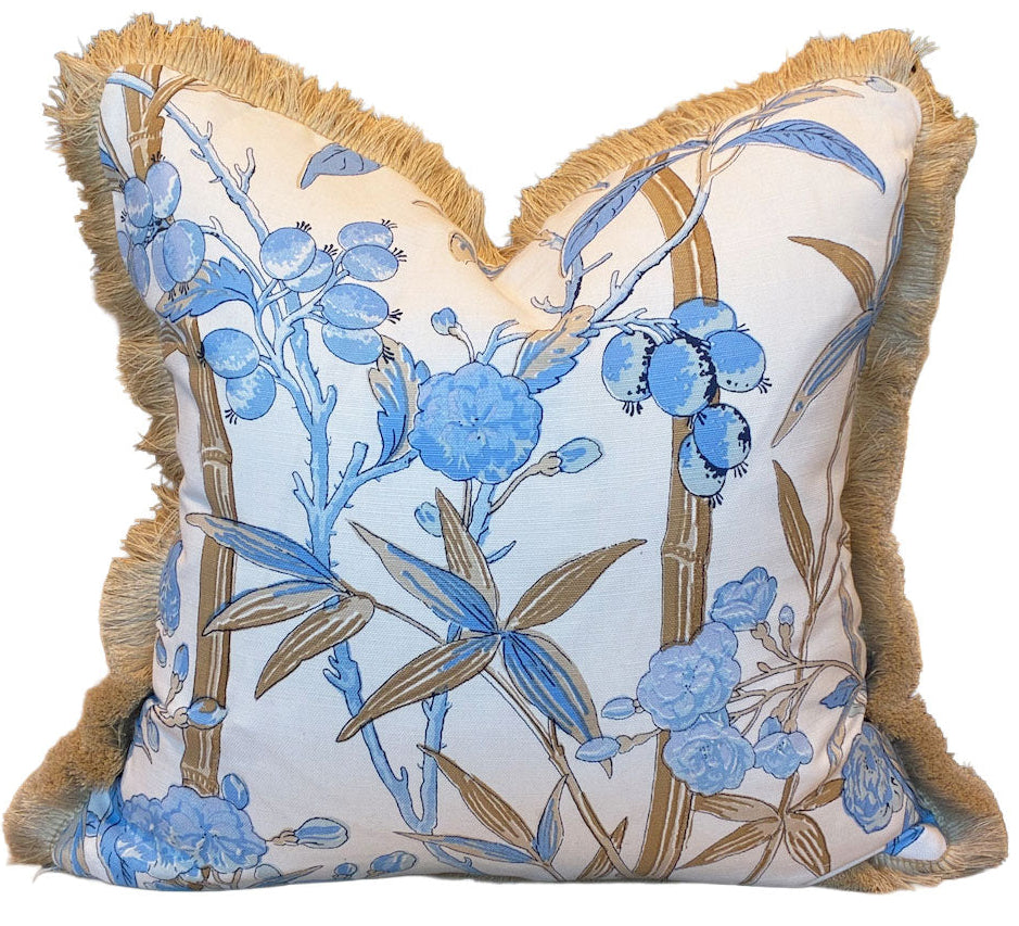 The Enchanted Garden Pillow by Hive Custom Pillows features a blue floral and branch pattern on white fabric with tan fringe trim—a luxurious accent crafted from premium materials.