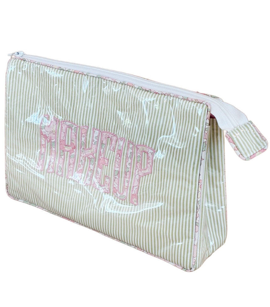 Keep your beauty essentials organized with the Walker Valentine Large Helen Cosmetic Case—"MAKEUP" in bold pink letters on a light green and white striped rectangular bag with pink trim and zippered closure.