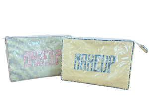 The Walker Valentine Large Helen Cosmetic Case features a rectangular travel bag with striped patterns, “MAKEUP” printed on the front, and a zipper closure—ideal for stylish, on-the-go beauty storage.