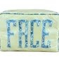 The Walker Valentine Large Milan Cosmetic Case, "FACE," is a rectangular zippered organizer with yellow stripes and bold blue floral letters—ideal as a stylish travel makeup bag.