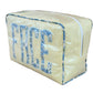The Large Milan Cosmetic Case by Walker Valentine features yellow and white stripes with "FACE" in large blue patterned letters—a stylish zippered travel makeup bag and beauty organizer.