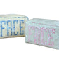 Two Walker Valentine Large Milan Cosmetic Cases with "FACE" embroidery—one in blue, one in pink—feature striped fabric and are perfect as beauty organizers or travel makeup bags.