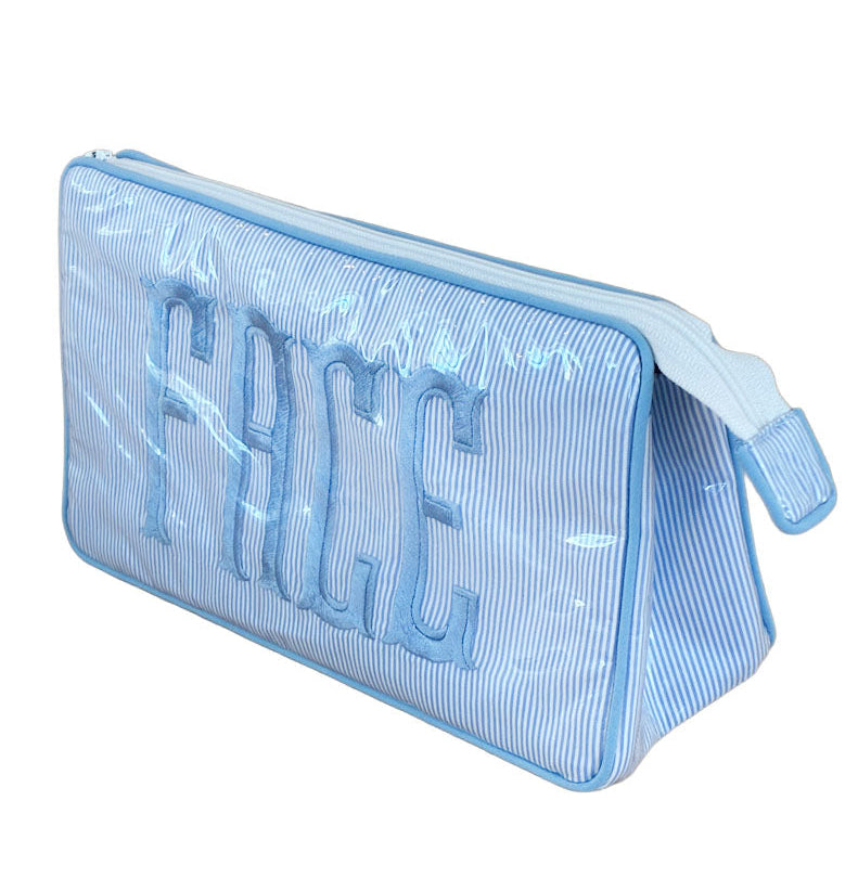 The Walker Valentine Small Helen Cosmetic Case, "FACE" features light blue and white stripes, bold "FACE" embroidery, and a zippered pouch—perfect as a travel cosmetic or makeup bag.