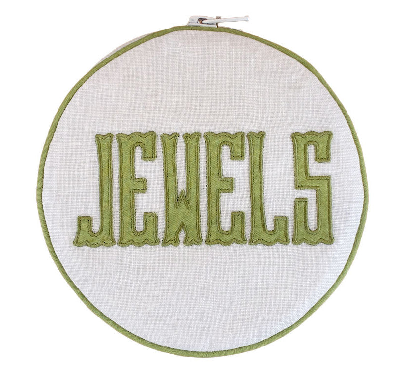 The Walker Valentine Jewelry Roll, "JEWELS," features bold green embroidery on white fabric—a stylish and practical accent for organizing or traveling with your jewelry.