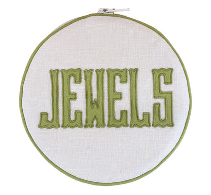The Walker Valentine Jewelry Roll, "JEWELS," features bold green embroidery on white fabric—a stylish and practical accent for organizing or traveling with your jewelry.