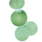 A round, open green Walker Valentine "JEWELS" Jewelry Roll with three matching green reusable pads displayed beside it on a white background.