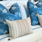 Three decorative pillows by Hive Custom Pillows are on the bed: two large Fall Pagoda Blue Pillows with white scenic patterns, and one smaller striped pillow featuring tassels.