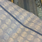 Close-up of the Ovals Pillow with Water Cord Trim by Hive Custom Pillows—featuring light blue and white patterned fabric, a blue seam, and textured metallic detail to highlight the premium materials in our handmade collection.