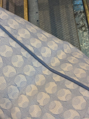 Close-up of the Ovals Pillow with Water Cord Trim by Hive Custom Pillows—featuring light blue and white patterned fabric, a blue seam, and textured metallic detail to highlight the premium materials in our handmade collection.
