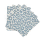 Four blue and white napkins from Matouk's Iconic Leopard Sky Tabletop Collection are stacked on a white background, bringing a bold accent to your classic table linens.