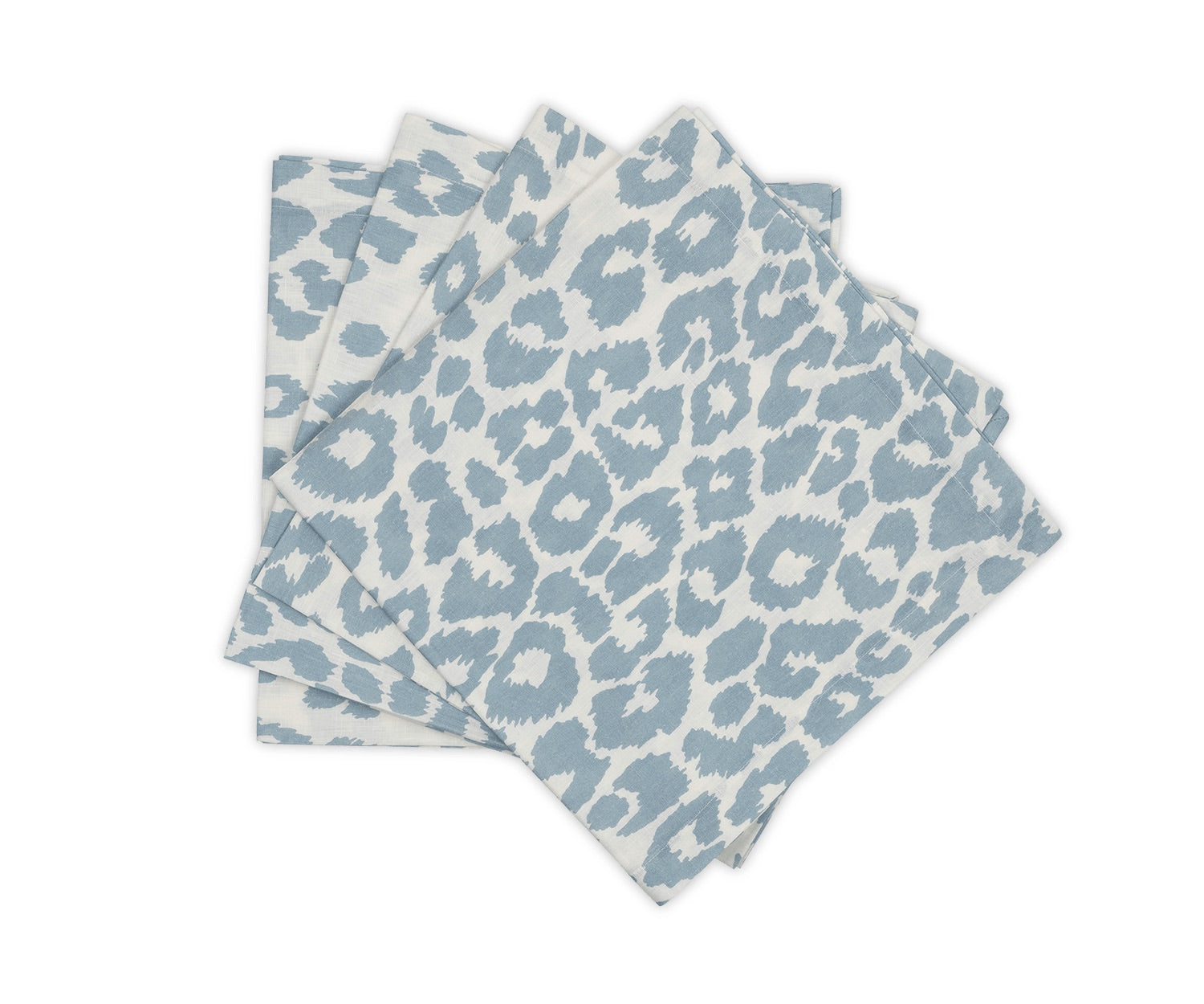Four blue and white napkins from Matouk's Iconic Leopard Sky Tabletop Collection are stacked on a white background, bringing a bold accent to your classic table linens.