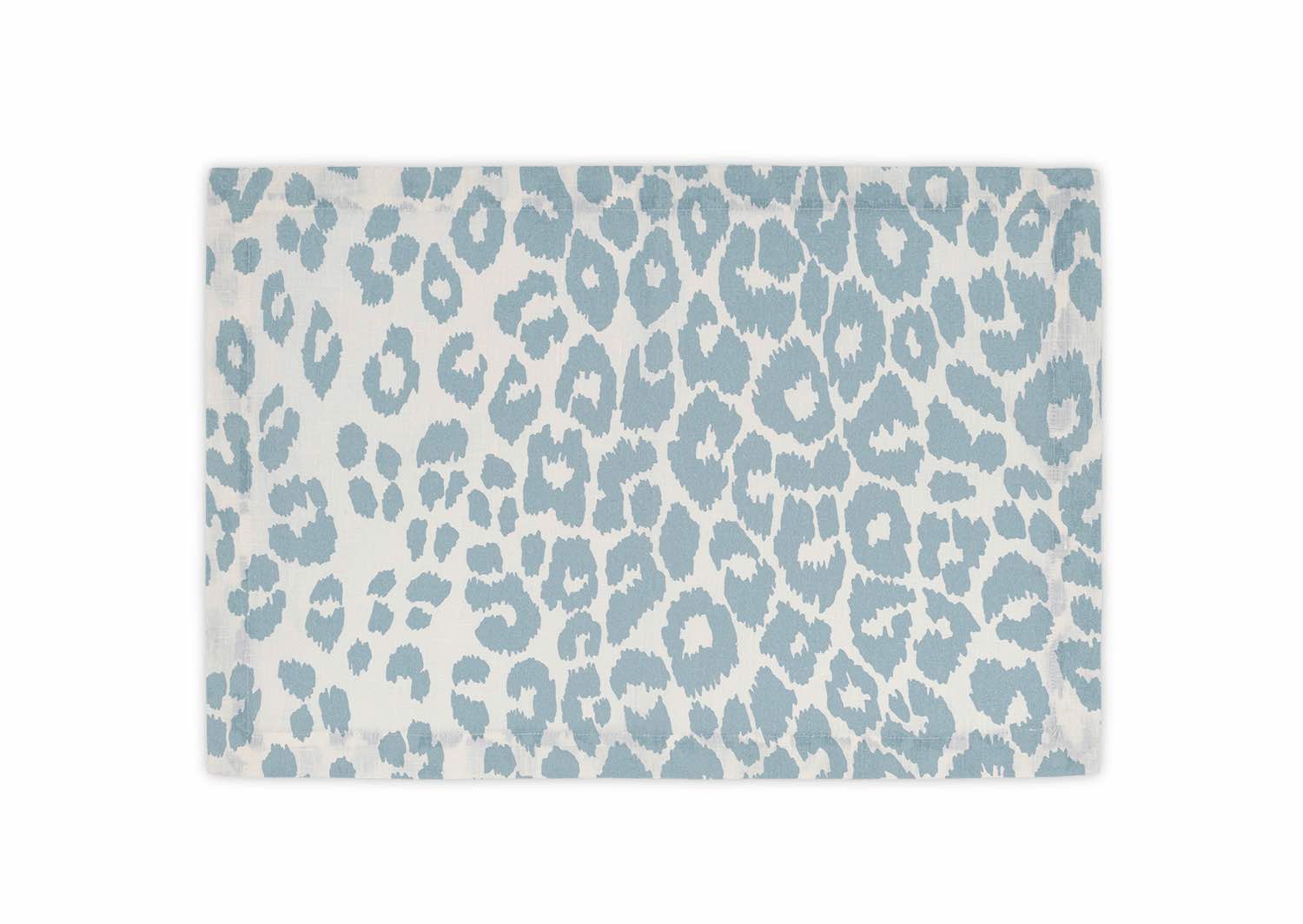 The Matouk Iconic Leopard Sky Tabletop Collection includes a classic linen napkin in blue and white, elegantly folded against a plain background to add sophistication to any table setting.