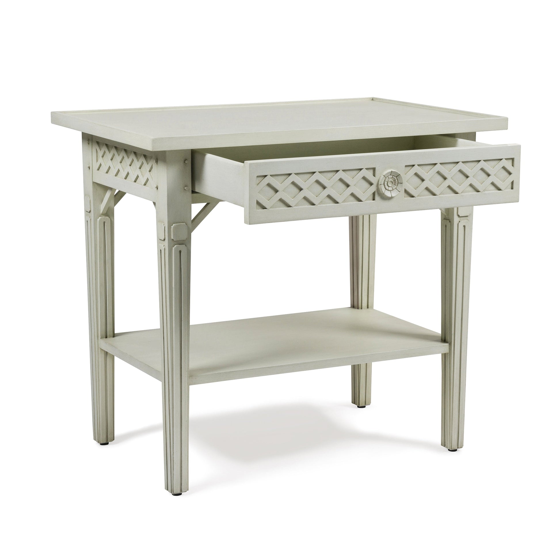 The Inge Side Table by Bunny Williams features a Swedish White finish, decorative latticework, a concealed drawer, and a lower shelf.