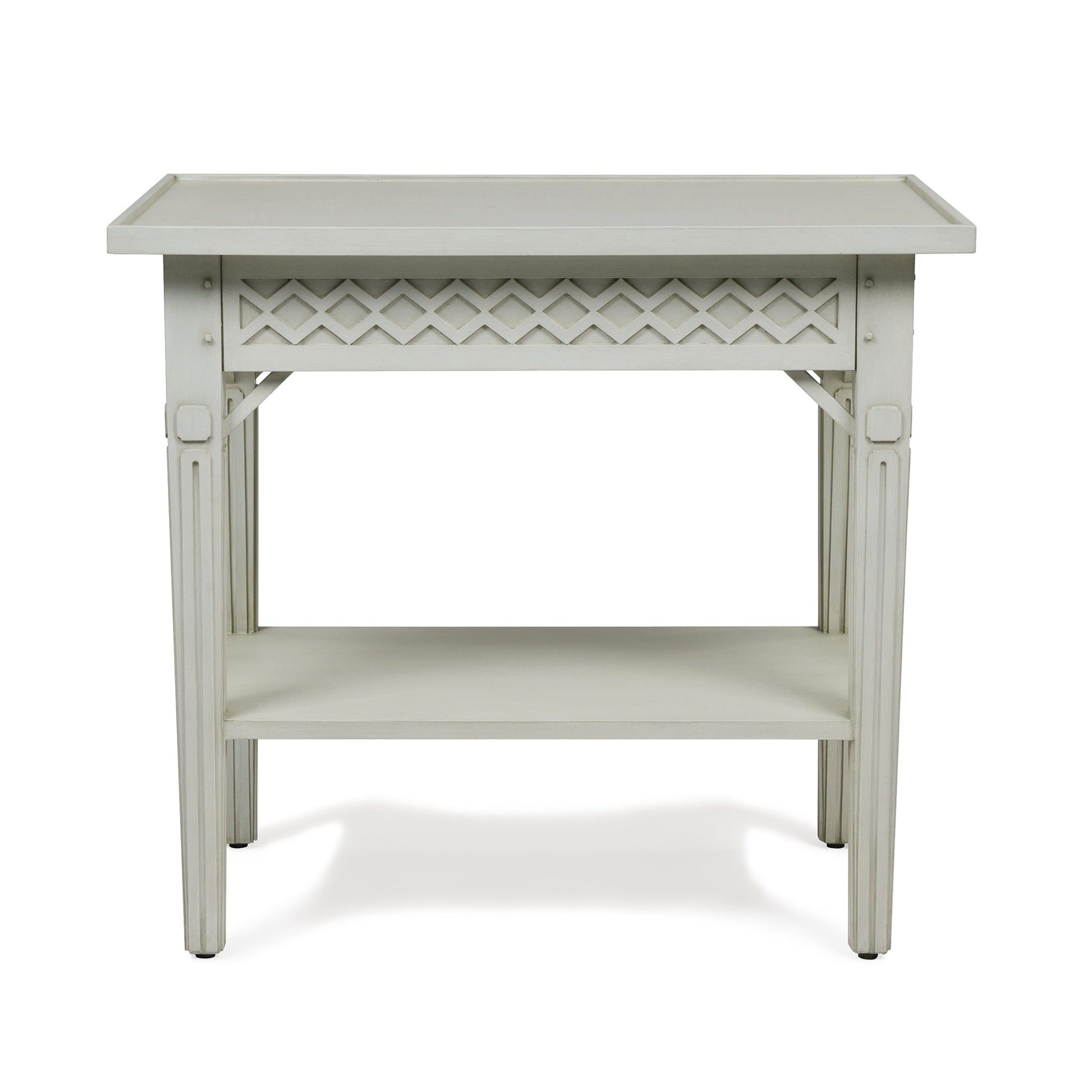 The Inge Side Table by Bunny Williams features a rectangular white wooden design with a decorative lattice apron, four straight legs in a Swedish White finish, and a convenient lower shelf.