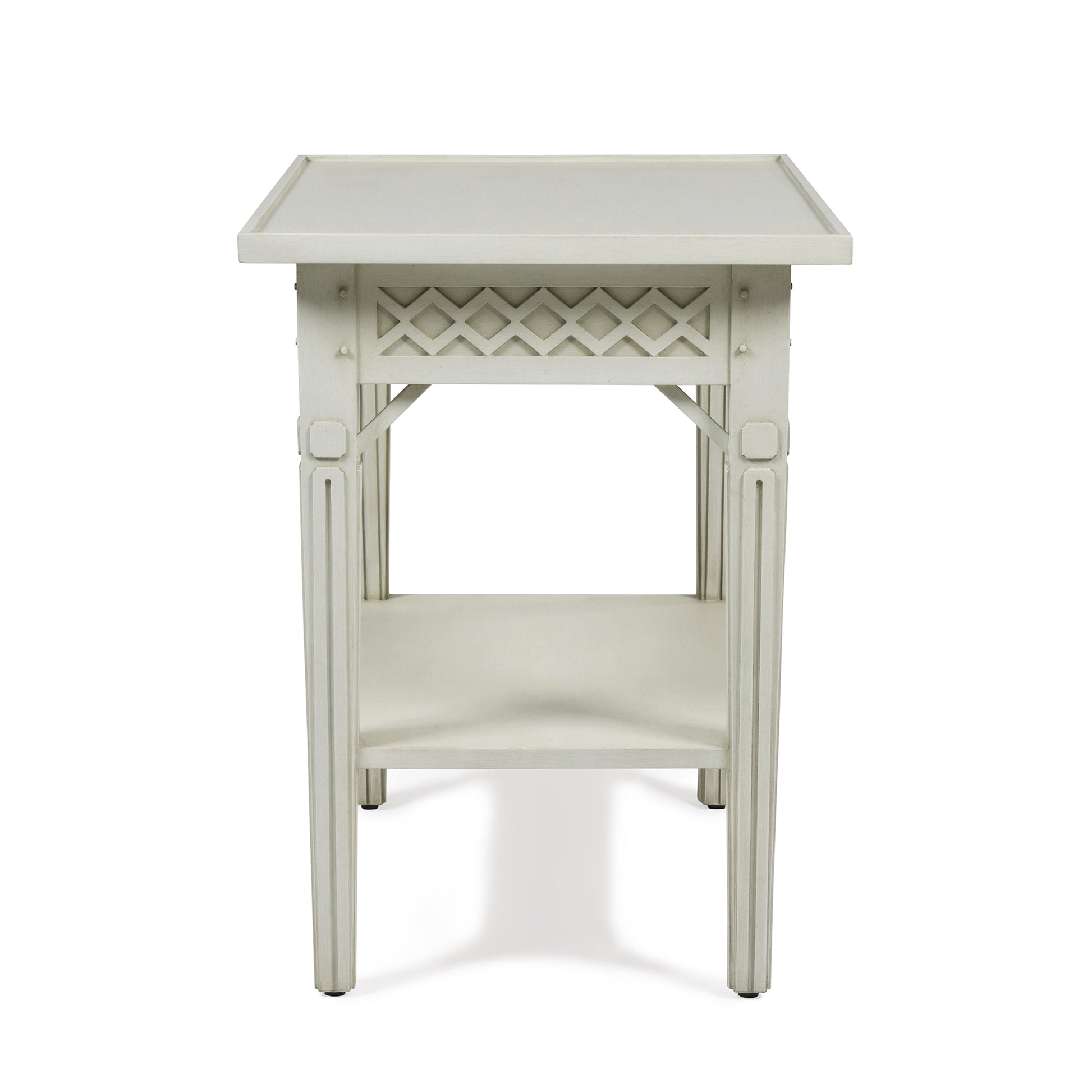 The Inge Side Table by Bunny Williams features a rectangular top, decorative lattice under the apron, a lower shelf, and a concealed drawer—all in a classic Swedish White finish.