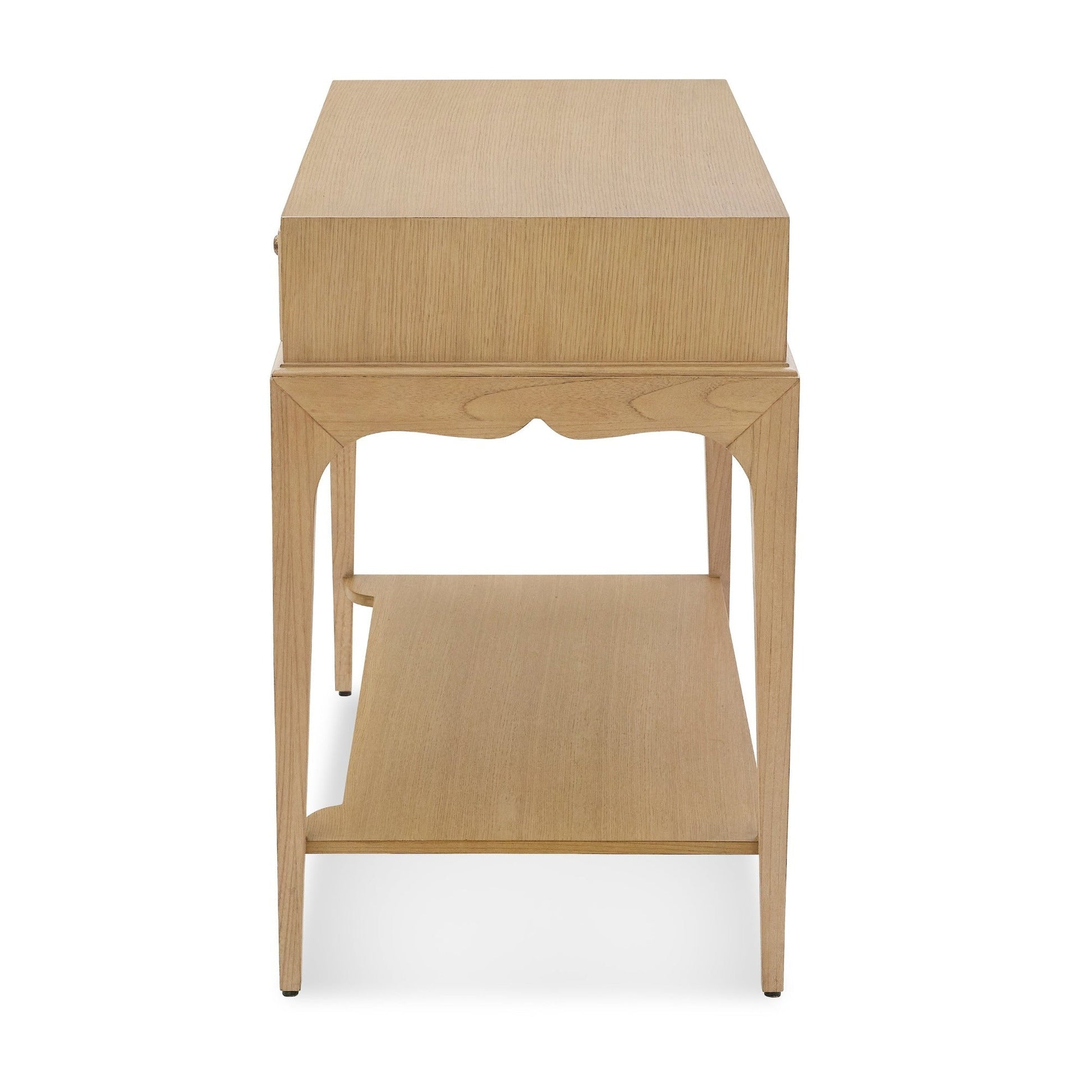 Front view of the Bunny Williams Isabella Side Table in grey-washed oak, with a boxy top, decorative curved apron, and lower shelf.