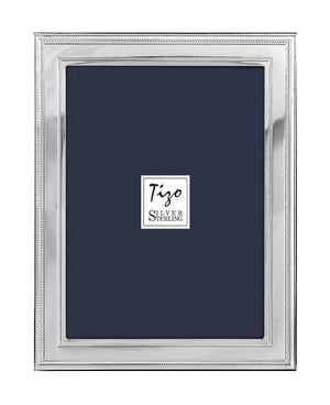 The Flat Double Bead Border Sterling Silver Frame Collection by Tizo Design features a tarnish-resistant rectangular silver frame with a simple, polished border—a refined accent for any room.
