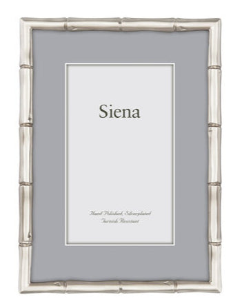 The Siena Bamboo Silverplate Frame Collection by Tizo Design features a silver bamboo frame with a gray mat and minimalist style, ideal for displaying cherished memories with "Siena" elegantly presented at the center.
