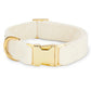 The Velvet Dog Collar Collection by Foggy Dog features a cream velvet collar with a gold buckle and D-ring, ideal as a wedding dog accessory, shown on a white background.