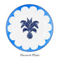 A round dessert plate from the Aquazzura Casa Jaipur Blue Dinnerware Collection, handcrafted from porcelain, features a blue and white scalloped border with a central blue palm tree and pineapple design.