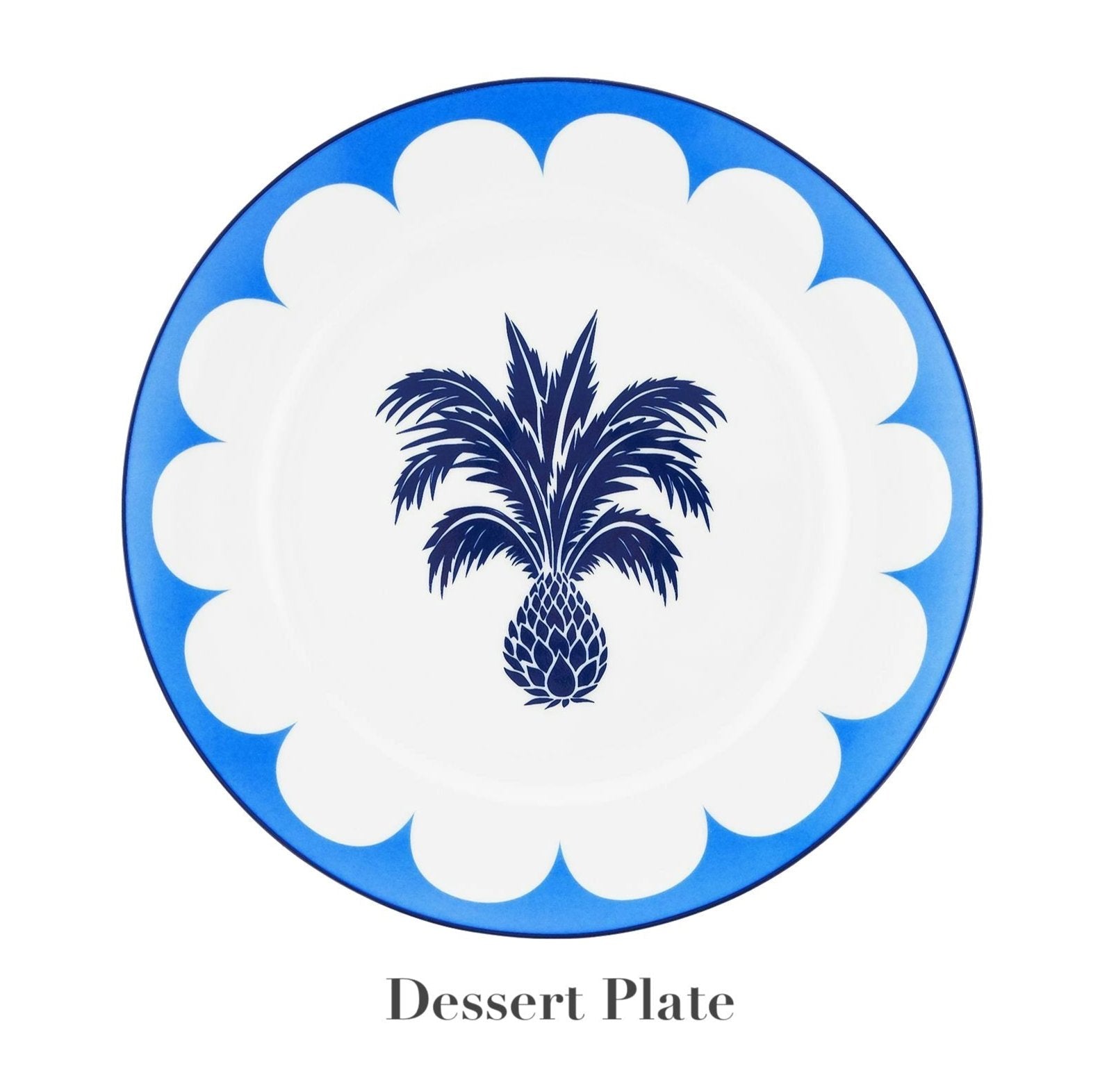 A round dessert plate from the Aquazzura Casa Jaipur Blue Dinnerware Collection, handcrafted from porcelain, features a blue and white scalloped border with a central blue palm tree and pineapple design.
