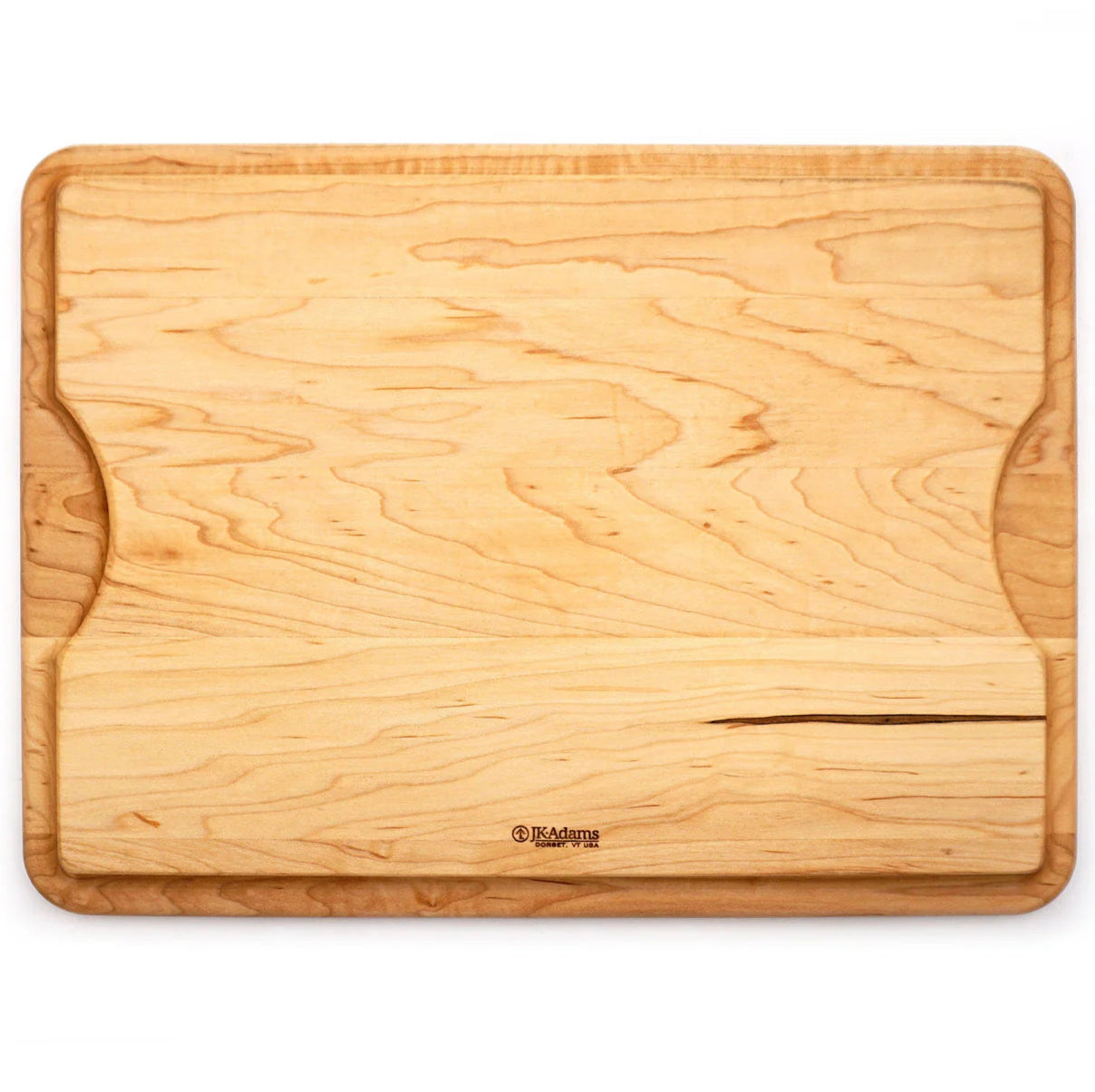 The J.K. Adams Maple BBQ Cutting Board features a groove along one edge, a lighter wood strip near the bottom, and natural wood grain patterns—perfect for all your barbecue carving needs.