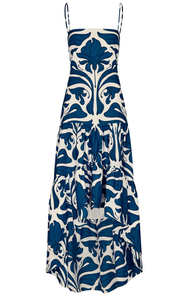 A sleeveless, ankle-length dress with thin straps and a ruffled hem, featuring a bold blue print reminiscent of the Andres Otalora Joya Colonial Dress by Andres Otalora.