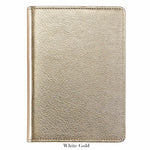 The Graphic Image 7" Leather Notebook in metallic white gold features textured leather and a closed design, shown against a white background—a perfect companion for capturing inspiration anywhere.