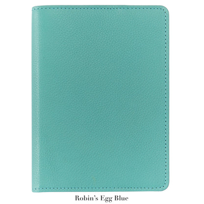 A 7" Leather Notebook by Graphic Image in robin’s egg blue, featuring a textured cover and closed design, is displayed on a white background. Below, the text reads “Robin’s Egg Blue.”.