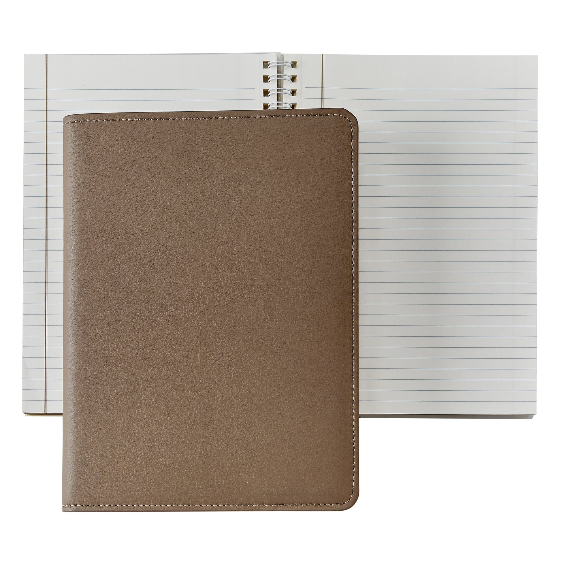 A 7" Leather Notebook by Graphic Image, a true writer's companion, rests atop an open spiral-bound lined notebook.