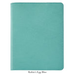 The Graphic Image 9" Leather Notebook, featuring a textured refillable cover in robin’s egg blue, is displayed closed against a white background.