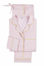 The Matouk Jasper Pajama Set features light pink cotton sateen with yellow piping, including a button-up long-sleeve top and drawstring pants.