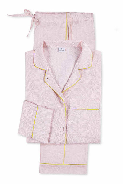 The Matouk Jasper Pajama Set features light pink cotton sateen with yellow piping, including a button-up long-sleeve top and drawstring pants.
