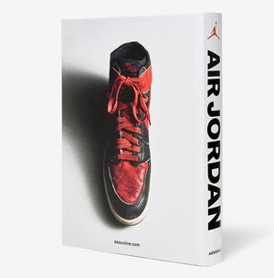 Air Jordan" by Assouline is a book celebrating Michael Jordan’s legacy and the iconic Jordan Brand, featuring a red and black Nike Air Jordan sneaker on the cover.