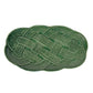 An oval green ceramic platter with a raised rope pattern from Juliska’s Le Panier Mystic Knot Basil Dinnerware and Serveware Collection, perfect for adding elegance to your holiday table.