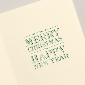 The Crane Silver and Gold Beaded Tree Card Set features a cream-colored card with green text reading, "We wish you a Merry Christmas and a Happy New Year," reminiscent of an engraved holiday card.