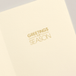 The Oh What Fun Card Set by Crane features an open cream-colored holiday card with "GREETINGS of the SEASON" elegantly printed in gold on the right—perfect for sending festive cheer.