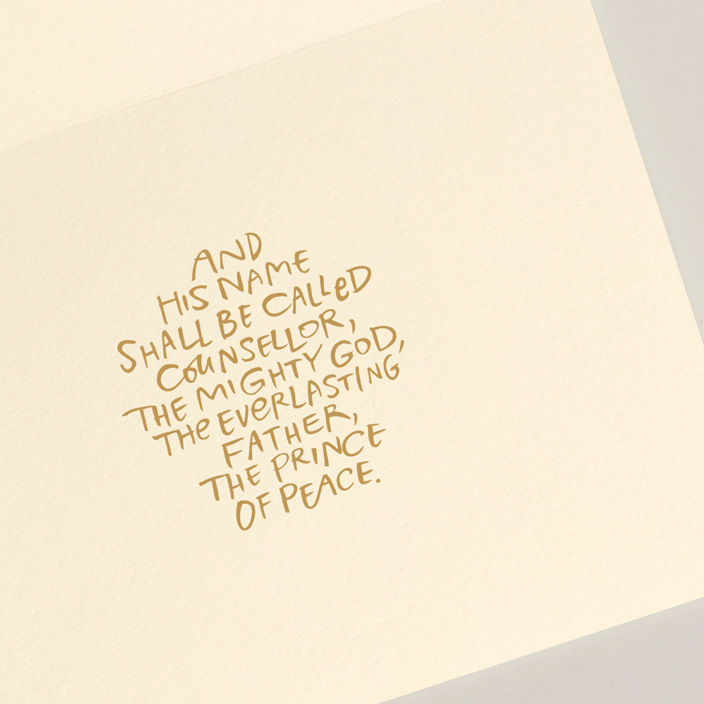 The Away In A Manger Card Set by Crane features a handwritten Bible verse: "And his name shall be called Counsellor, The Mighty God, The Everlasting Father, The Prince of Peace," ideal for a heartfelt Christmas card.