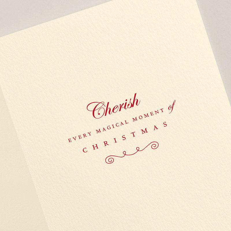 The Crane Engraved Gingerbread Cottage Card Set features cream cards with red text saying, "Cherish every magical moment of Christmas," in a decorative font—ideal for boxed card sets or pairing with scarlet lined envelopes.