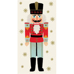 A toy soldier nutcracker in a red uniform and tall black hat, surrounded by gold snowflakes on a cream background from the Hester & Cook Nutcracker Collection.