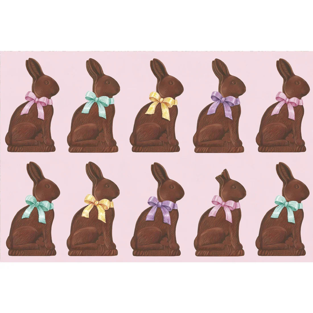Ten Hershey's Chocolate Bunny Place Setting Collection rabbits by Hester & Cook, each with a colorful bow—blue, yellow, purple, and pink—are displayed in two neat rows on a light pink background.