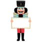 A Nutcracker Collection figure in uniform and a tall hat, holding a blank rectangular sign with a gold border.