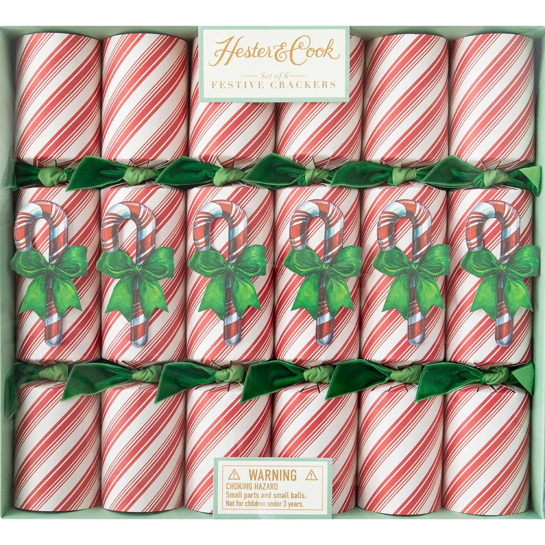 Hester & Cook Candy Cane Collection: a box of six red and white peppermint-striped festive crackers, each accented with a green bow and a candy cane illustration for a holiday gathering.
